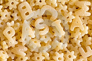 Close up on alphabet pasta spelling the word pasta