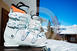 Close-up of alpine ski boots on balcony rail -vacation concept