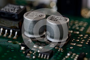 Close up aluminum electrolytic capacitors on PCB photo