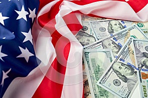 Close up of american flag and dollar cash money. Dollar banknote and United States flag background. Economy of USA