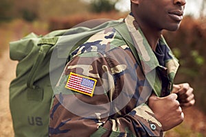 Close Up Of American Flag On Uniform Of Soldier Carrying Kitbag Returning Home On Leave