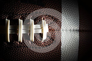 Close-up of an American football on black background