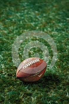 close-up of an american football on grass field