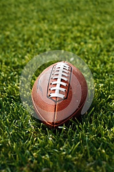 close-up of an american football on a grass field