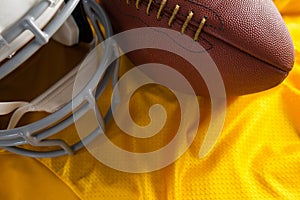 Close up of American football and helmet on jersey