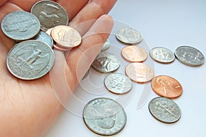 American quarter, dime coins in hand on dollar usa background