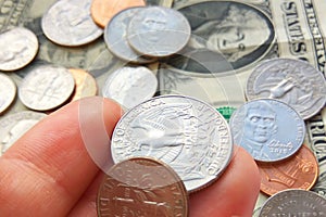 American quarter, dime coins in hand on dollar usa background