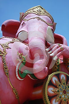 Close-up ancient carving of clining peace Ganesha god, god of successful with blue clear photo