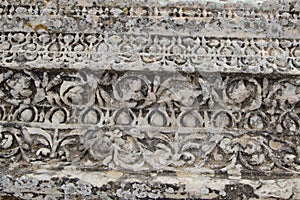 Close up of ancient marble block with carved patches and moldy