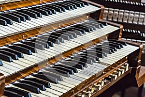 Close up of ancient pipe organ keyboards in european cathedral