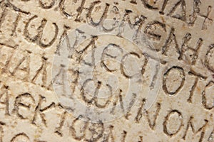 Close up of an ancient text carved on marble.