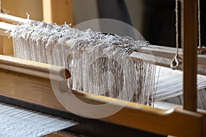 Close-up of ancient traditional hand weaving loom or weaving machine, selective focus