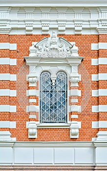 Close-up of ancient vintage arch window with cast iron white lattice, pattern