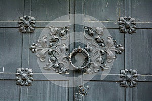 Close-up of ancient vintage metal door with cast iron floral deorative ornament