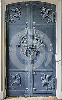 Close-up of ancient vintage metal door with cast iron floral deorative ornament