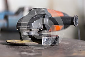 Close-up of angle grinder lying on table