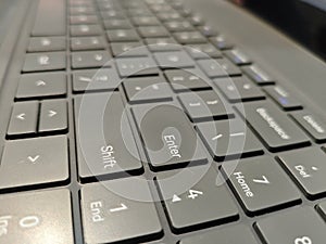 Close up Angled View of a Modern Laptop Keyboard with Backlit Keys
