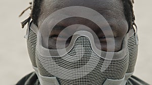 Close up, angry african american black man with mask over his face ready for fight