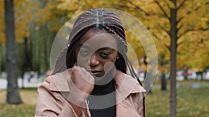 Close-up angry aggressive african american woman looking at camera threatening shows fist serious dissatisfied young