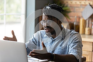 Close up angry African American man having problem with laptop