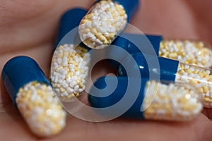 Close up of antibiotics capsules or painkillers isolated on white. Medicine concept, pills close up, copy space