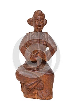 Close-up of antique carved wooden figurine or sculpture from a asian man is sitting and playing a music instrument. Carved