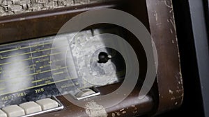 Close up of the antique radio set, vintage background with the reflection of a man and a window on glass panel. Action