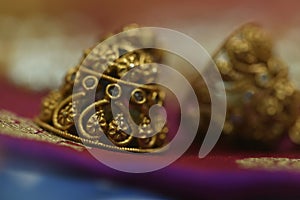 antique stone studded gold jewelry necklace on a lovely purple silk fabric photo