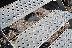 Close-up of antislip steps of perforated metal plates photo
