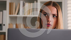 Close up anxiety worried Caucasian businesswoman with computer in office serious girl frown puzzled stressed woman