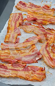 Close-up of appetizing slices of smoked bacon. Isolated on white background.