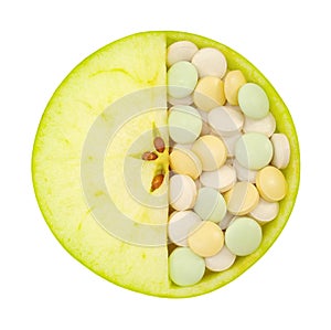 Close up of apple and pills isolated