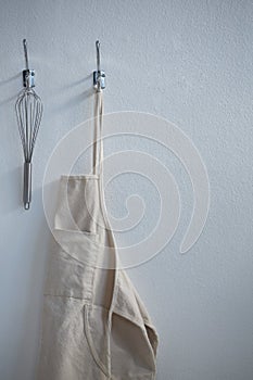 Apron and whisker hanging on hook photo