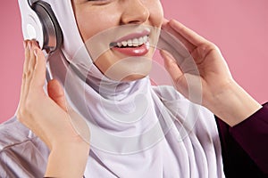 Close up. Arab woman in hijab listens to music