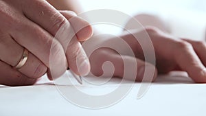 Close-up of an architect`s hands. Professional real estate designer at the workplace in the office.