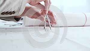 Close-up of an architect`s hands. Professional real estate designer at the workplace in the office.