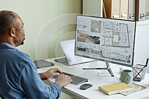 Close up of architect using computer with 3D blueprints