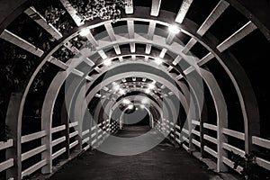 Close up architecture of wooden tunnel in outdoor garden at night time.