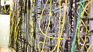 Close up of arranged stack of colorful electronic wires in communication control room. Stock footage. Details of server