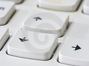 Close up of arrow keys on white keyboard of modern laptop