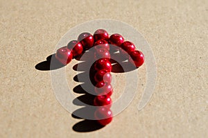 Close-up of   arrow sign made of red plastic balls. Indications to a certain place photo