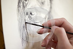 Close Up Of Artist Sitting At Easel Drawing Picture Of Dog In Charcoal