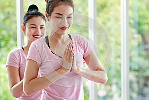 Close up Asian beautiful sportive healthy women with hair tied wearing pink sport shirt and black elastic pants, doing exercise or