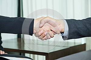 Close up asian business people handshake deal with agreement at