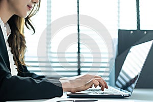 Close up of Asian business woman work in office, typing on keyboard. Attractive professional female employee worker in formal wear