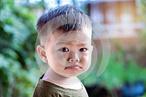 Close up of Asian child boy`s face with tears. Upset crying and mad little toddler boy.