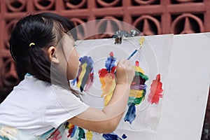 Close up of Asian child girl is painting on the canvas.
