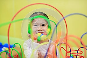 Close-up Asian child girl playing educational toy for brain development at kids room