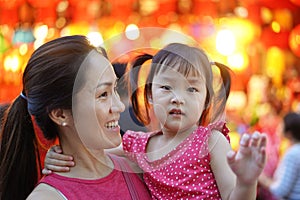 Close-up of Asian chinese mother and daughter shopping in china town during festive seasons