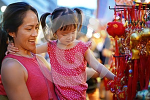 Close-up of Asian chinese mother and daughter shopping in china town during festive seasons